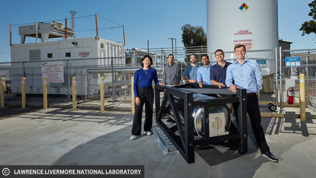 Picture of the researchers standing next to Verne’s cryo-compressed hydrogen storage system, with LLNL’s cryogenic hydrogen fueling facility in the background.